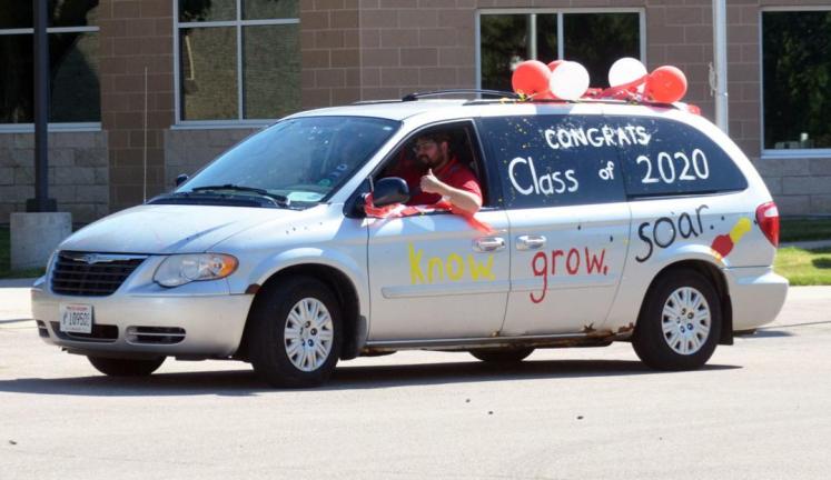 With an inspirational message painted across the side, and balloons along the top, a festive van June 8 pulls through the Wisconsin School for the Deaf parking lot during the graduation parade.