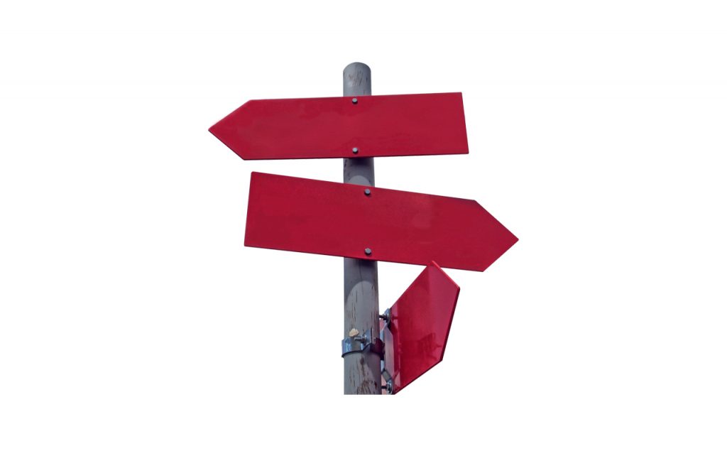 Post with three red arrow signs pointing different directions.