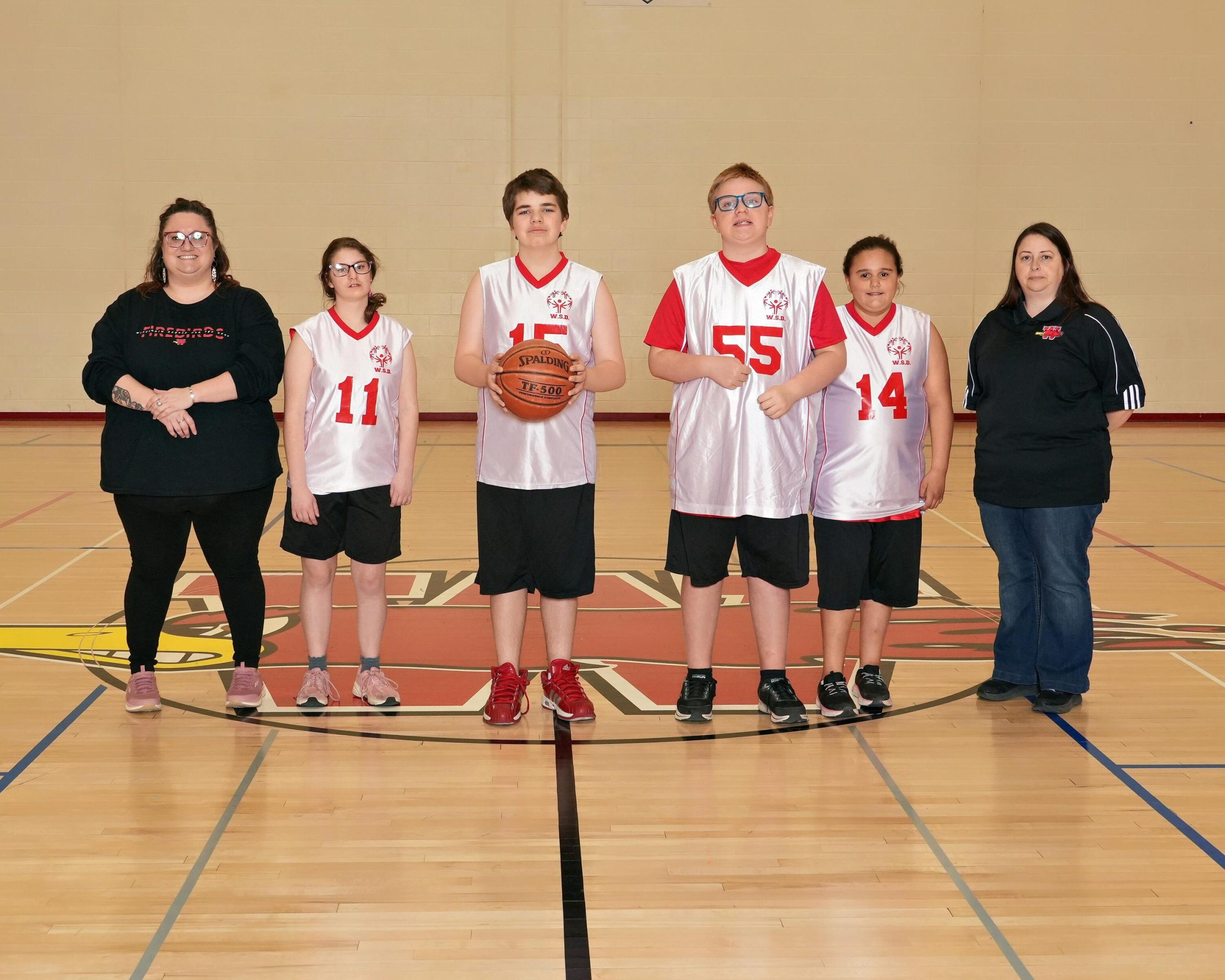 Special Olympics baskteball team photo with 4 athletes and 2 coaches