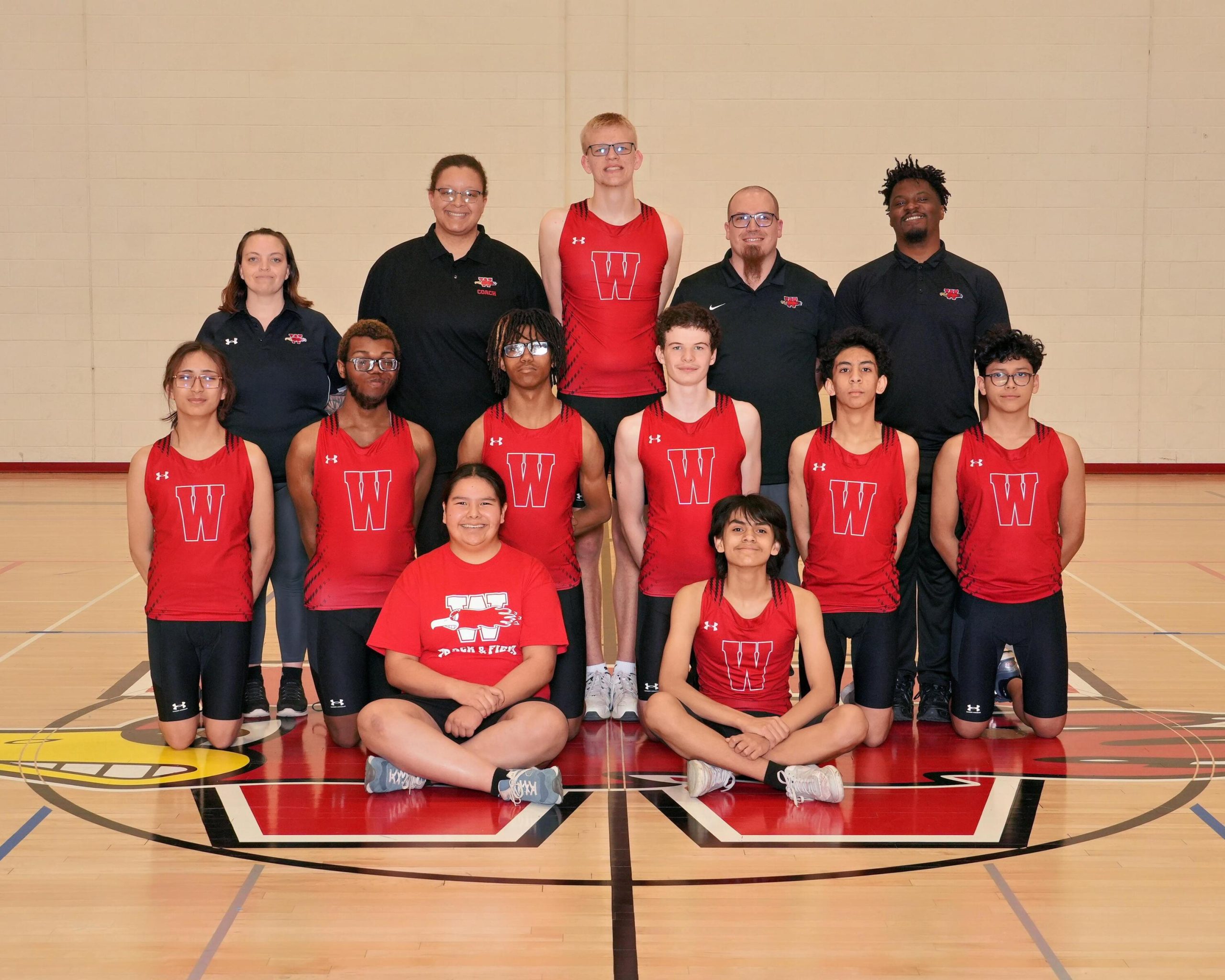 Varsity Boys Track & Field Photo with 4 coaches.