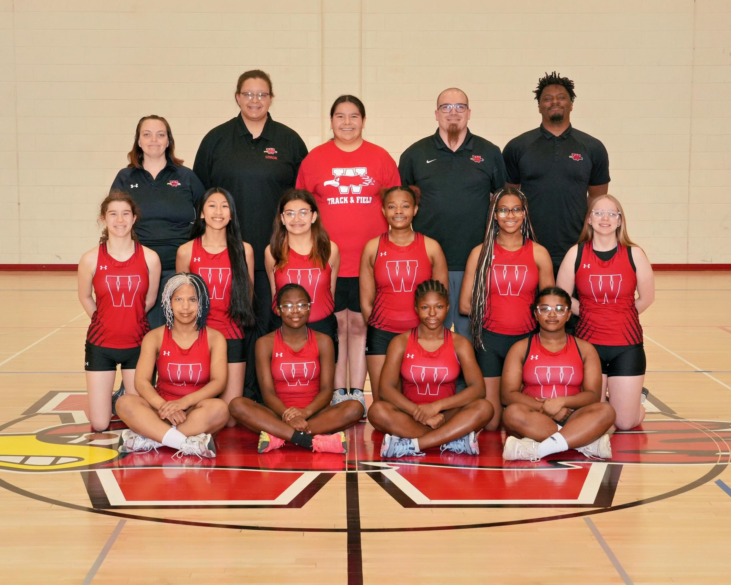 Varsity Girls Track & Field Photo with 4 coaches.