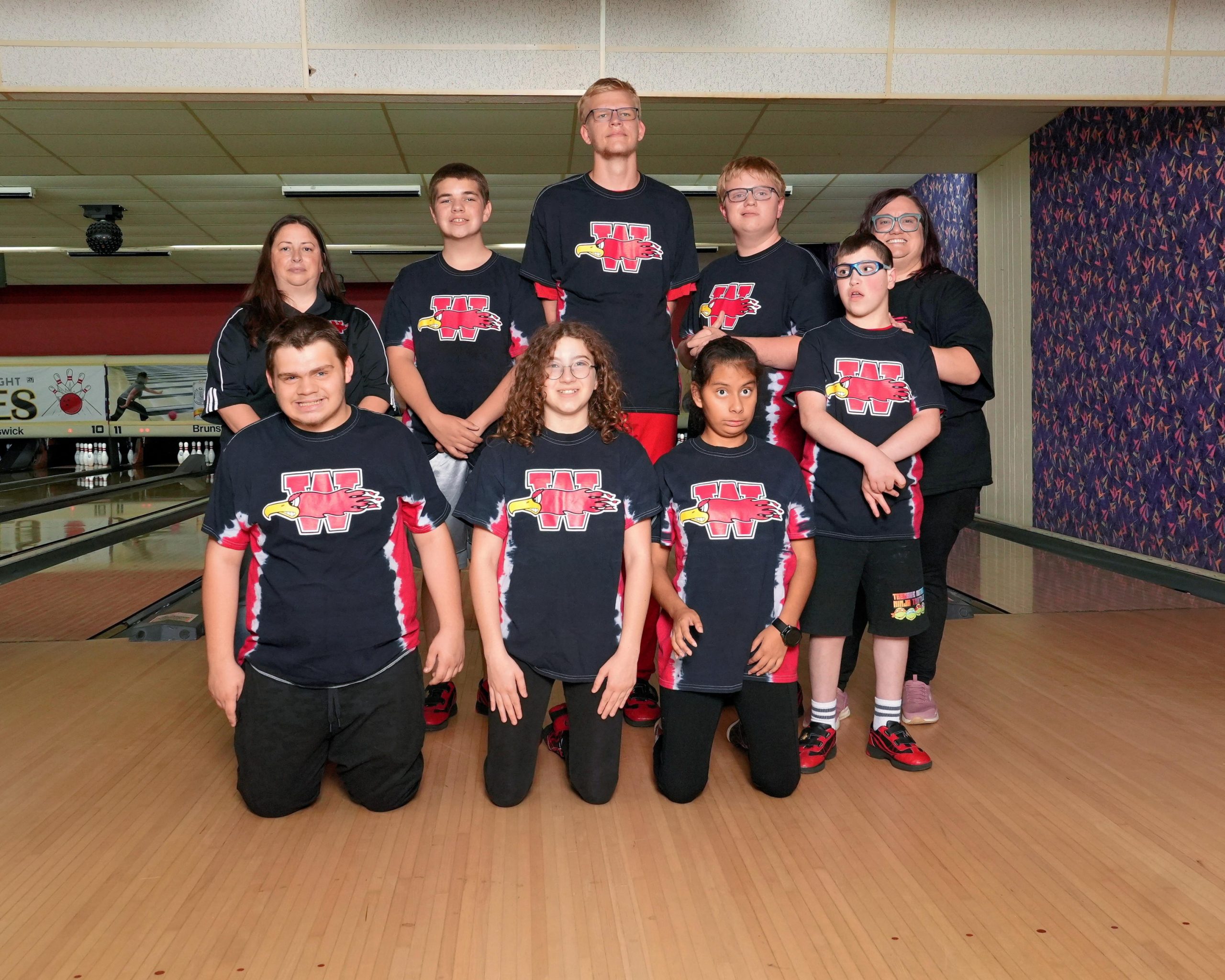 Special Olympics bowling team photo with 7 athletes and 2 coaches